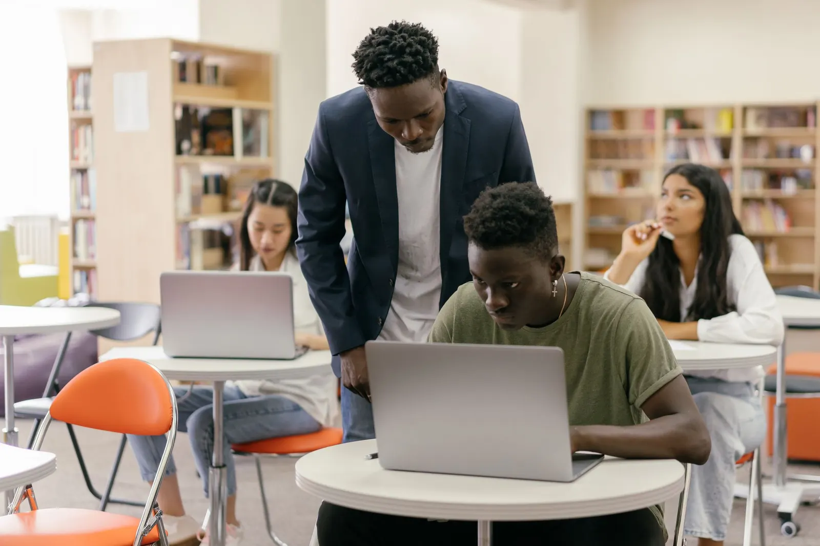 Students working on laptops in a university library